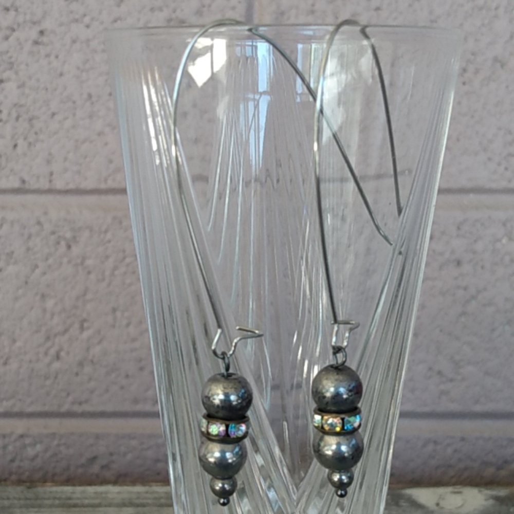 Unique silver tone, bright crystals and dark steel